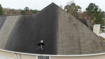 Aerial drone view of a residential roof with algae streaking in Mocksville NC before soft wash roof cleaning